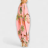 Linda - Působivé šaty s asymetrickými ramínky a potiskem kokosových palem